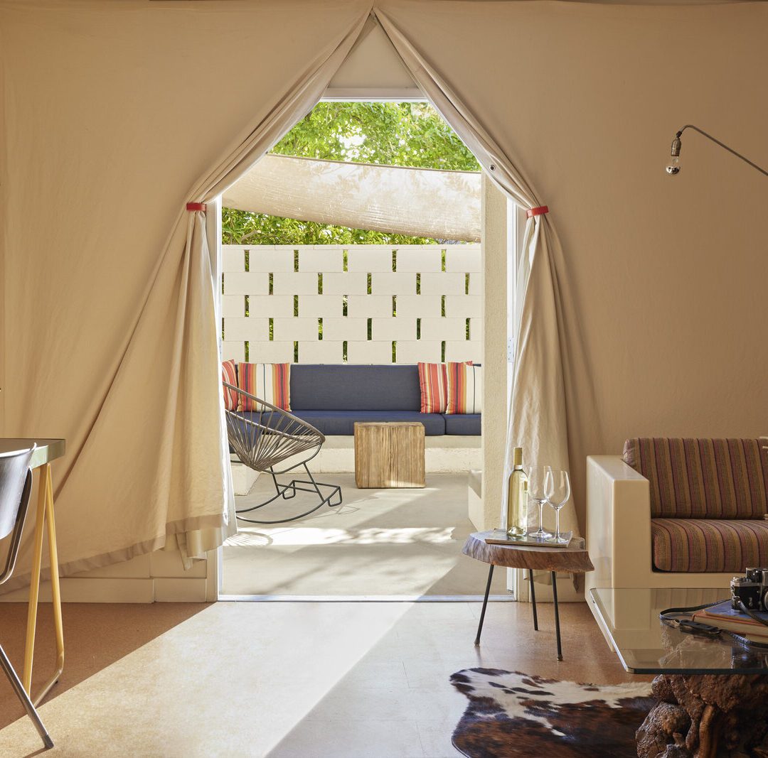 a canopy door is flanked by a couch