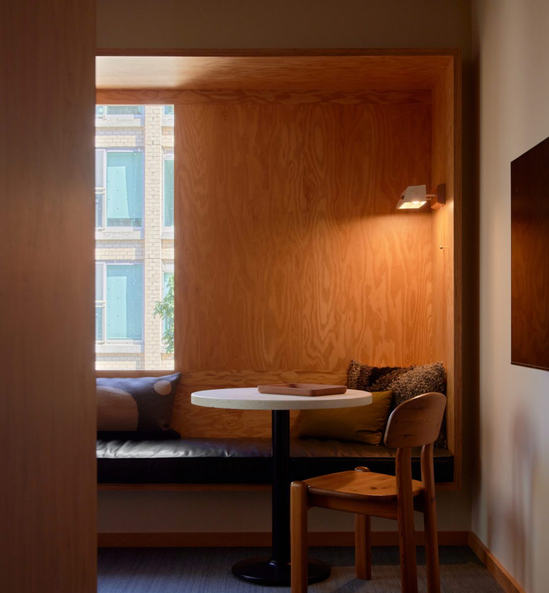 A black leather seating area is next to a table; plush cushions provide added comfort