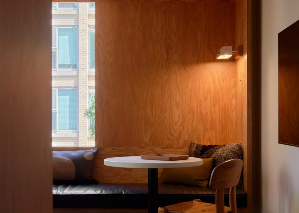 A black leather seating area is next to a table; plush cushions provide added comfort