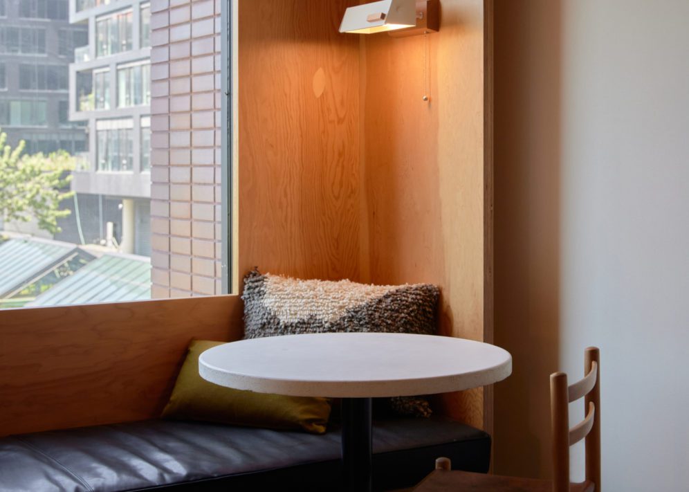 A black leather seating area is next to a table; plush cushions provide added comfort